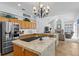 Bright kitchen featuring a large island, modern appliances, and elegant countertops at 3816 Little Country Rd, Parrish, FL 34219