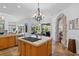 Kitchen island with a stone archway leading to a living room and views of the pool at 3816 Little Country Rd, Parrish, FL 34219