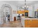 Spacious kitchen featuring a stone archway, stainless steel appliances, and stone tile floors at 3816 Little Country Rd, Parrish, FL 34219