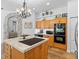 Spacious kitchen featuring a stone archway and stainless steel built-in appliances at 3816 Little Country Rd, Parrish, FL 34219