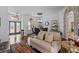 Open concept living area with stone archway, hardwood floors and bright natural light at 3816 Little Country Rd, Parrish, FL 34219