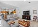 Open-concept living area with kitchen, comfortable seating, and entertainment center at 3816 Little Country Rd, Parrish, FL 34219