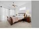 Bright main bedroom features a ceiling fan, neutral decor, and soft natural light at 3816 Little Country Rd, Parrish, FL 34219
