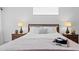 Bright main bedroom is elegantly furnished with two nightstands, lamps, and neutral decor at 3816 Little Country Rd, Parrish, FL 34219