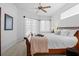 Bright main bedroom features a ceiling fan, neutral decor, and soft natural light at 3816 Little Country Rd, Parrish, FL 34219