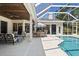 Relaxing covered patio features an outdoor dining area and a view of the inviting pool at 3816 Little Country Rd, Parrish, FL 34219