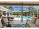 Relaxing outdoor patio with comfortable seating and serene views of the inviting pool at 3816 Little Country Rd, Parrish, FL 34219