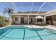 Sparkling pool in screened enclosure, surrounded by patio space and lush landscaping at 3816 Little Country Rd, Parrish, FL 34219