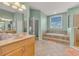 Inviting bathroom features a soaking tub with tile surround and walk-in shower creating a spa-like experience at 426 Magnolia Ave, Anna Maria, FL 34216