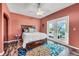 Bedroom featuring a wood bed frame, and double doors leading to a private balcony at 426 Magnolia Ave, Anna Maria, FL 34216