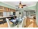 Open dining area featuring a wood table, fan and seating near a breakfast bar and kitchen at 426 Magnolia Ave, Anna Maria, FL 34216