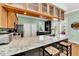 Bright kitchen with granite countertops, stainless steel appliances, breakfast bar, and ample storage at 426 Magnolia Ave, Anna Maria, FL 34216