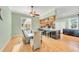 Bright kitchen and dining area with granite countertops, a breakfast bar and wood floors at 426 Magnolia Ave, Anna Maria, FL 34216