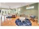 Inviting living room with wood floors, stylish seating, and French doors leading to outdoor space at 426 Magnolia Ave, Anna Maria, FL 34216
