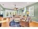Comfortable living room with a large sectional, ceiling fan, nautical accents, and view to outdoor space at 426 Magnolia Ave, Anna Maria, FL 34216
