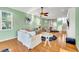 Bright living room featuring a large sectional, hardwood floors, nautical-themed decor, and ample natural light at 426 Magnolia Ave, Anna Maria, FL 34216