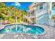 Backyard with a refreshing pool, lounge chairs, and beautiful landscaping at 426 Magnolia Ave, Anna Maria, FL 34216