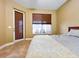Cozy bedroom featuring tile floors, a neutral color scheme, and access to the outdoor patio at 4721 Turnberry Cir, North Port, FL 34288