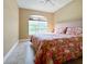 Cozy bedroom featuring a window with natural light and a decorative floral bed set at 4721 Turnberry Cir, North Port, FL 34288