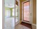 Entryway showcasing neutral paint, tile floors, and a view to another room at 4721 Turnberry Cir, North Port, FL 34288