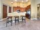 Eat-in kitchen featuring granite countertops, stainless steel appliances, tile flooring and three bar stools at 4721 Turnberry Cir, North Port, FL 34288