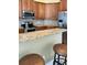 Granite countertops, stainless appliances, and wood cabinetry complement this kitchen with bar seating at 4721 Turnberry Cir, North Port, FL 34288