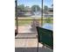 Relaxing view from the screened in patio showing the lake with fountain, landscaping and nearby homes at 4721 Turnberry Cir, North Port, FL 34288