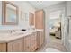 Bathroom featuring dual vanity sinks, mirrors, and access to a bedroom at 4821 Mount Vernon Dr # 4821, Bradenton, FL 34210