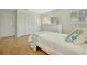 Cozy bedroom featuring wood floors, white furniture, shutters and built-in closets at 4821 Mount Vernon Dr # 4821, Bradenton, FL 34210