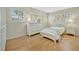 Bedroom with wood floors, white furniture, and bright natural light through shutters at 4821 Mount Vernon Dr # 4821, Bradenton, FL 34210
