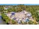 Aerial view of outdoor boat storage area surrounded by lush green trees and vegetation near the water at 4821 Mount Vernon Dr # 4821, Bradenton, FL 34210