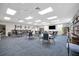 Bright community room with plenty of tables and chairs, bookshelves, and television for group activities at 4821 Mount Vernon Dr # 4821, Bradenton, FL 34210