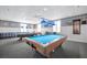 Well-lit game room with two pool tables, cozy seating, and stylish nautical wallpaper at 4821 Mount Vernon Dr # 4821, Bradenton, FL 34210