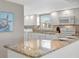 Bright kitchen features granite countertops, appliances, and a turtle decoration at 4821 Mount Vernon Dr # 4821, Bradenton, FL 34210