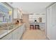 Contemporary kitchen with bright white cabinetry, a bar, and an open view to the living spaces at 4821 Mount Vernon Dr # 4821, Bradenton, FL 34210