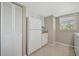 Galley kitchen features white appliances and cabinetry at 4821 Mount Vernon Dr # 4821, Bradenton, FL 34210