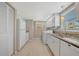 Galley kitchen includes appliances and washer and dryer in the same area at 4821 Mount Vernon Dr # 4821, Bradenton, FL 34210