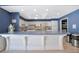 Stylish kitchenette with white cabinets, blue accents, modern appliances, and ample counter space at 4821 Mount Vernon Dr # 4821, Bradenton, FL 34210