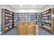 Cozy library featuring floor-to-ceiling bookshelves filled with books, and a central wooden cabinet at 4821 Mount Vernon Dr # 4821, Bradenton, FL 34210