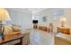 Bright living room with hardwood floors, white shutters, and a sofa at 4821 Mount Vernon Dr # 4821, Bradenton, FL 34210
