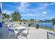 Picturesque patio with waterfront views, featuring comfortable seating and lush landscaping with bright sky at 4821 Mount Vernon Dr # 4821, Bradenton, FL 34210