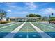 Outdoor shuffleboard court with well-maintained green playing surfaces, benches, and covered seating area at 4821 Mount Vernon Dr # 4821, Bradenton, FL 34210