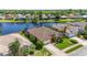 Aerial view of this beautiful single-Gathering home nestled near a serene lake, showcasing lush landscaping at 4918 Avon Ln, Sarasota, FL 34238