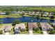 Stunning aerial view of a community with houses surrounding a beautiful lake, offering serene waterfront living at 4918 Avon Ln, Sarasota, FL 34238