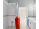 This well-lit bathroom showcases tile walls, a bathtub with shower, and a vanity with cabinet storage at 4918 Avon Ln, Sarasota, FL 34238