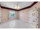 Bright bedroom with large window overlooking the water, tile flooring, and ensuite bath access at 4918 Avon Ln, Sarasota, FL 34238