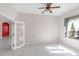 Bright bedroom features tile flooring, ceiling fan and plenty of natural light streaming in from the windows at 4918 Avon Ln, Sarasota, FL 34238