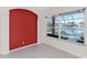 Bonus room with a bright red accent wall and sliding glass doors overlooks the pool and pond at 4918 Avon Ln, Sarasota, FL 34238