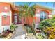Inviting front entrance with well-kept landscaping, a small palm tree, and a decorative glass door at 4918 Avon Ln, Sarasota, FL 34238