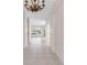 Spacious hallway with tile flooring, decorative lighting, and a view of the lake at 4918 Avon Ln, Sarasota, FL 34238